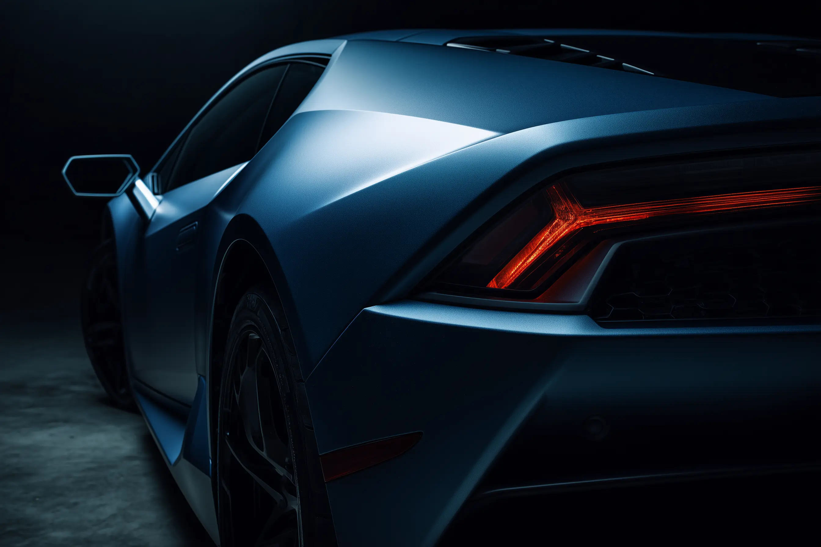 Modern luxury sports car with sophisticated matte blue-gray custom finish and dramatic LED lighting